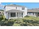 Two story home with covered patio and grassy backyard at 1740 Carnelian St, Deland, FL 32720