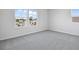 Well-lit bedroom featuring grey carpet and multiple windows at 1740 Carnelian St, Deland, FL 32720