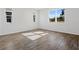 Bright bedroom with wood-look tile flooring and large windows at 1740 Carnelian St, Deland, FL 32720
