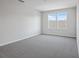 Spacious bedroom with grey carpet and two large windows at 1740 Carnelian St, Deland, FL 32720