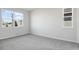 Bright bedroom with gray carpet, neutral walls, and large windows at 1740 Carnelian St, Deland, FL 32720