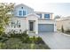 Two-story home with gray and blue exterior, two-car garage, and landscaping at 1740 Carnelian St, Deland, FL 32720