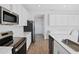 Modern kitchen featuring stainless steel appliances and white cabinetry at 1740 Carnelian St, Deland, FL 32720