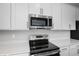 Stainless steel appliances and white cabinets in a modern kitchen at 1740 Carnelian St, Deland, FL 32720