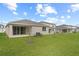 Green backyard with well-maintained lawn and young trees at 1742 Carnelian St, Deland, FL 32720