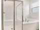Bathroom featuring a glass enclosed shower and soaking tub with subway tile at 1742 Carnelian St, Deland, FL 32720