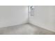 Clean, carpeted bedroom with a bright window and neutral decor at 1742 Carnelian St, Deland, FL 32720