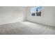 Bright bedroom featuring plush carpeting and a large window with natural light at 1742 Carnelian St, Deland, FL 32720