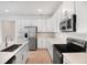 White kitchen with stainless steel appliances, island, and ample counter space at 1742 Carnelian St, Deland, FL 32720