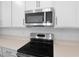 Close-up of stainless steel appliances and stylish countertop in this modern kitchen at 1742 Carnelian St, Deland, FL 32720