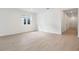 Bright living room with wood-look tile flooring and a large window providing natural light at 1742 Carnelian St, Deland, FL 32720