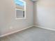 Simple bedroom with neutral walls and carpeted floor at 1744 Carnelian St, Deland, FL 32720