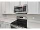 Stainless steel range and microwave in a modern kitchen at 1744 Carnelian St, Deland, FL 32720