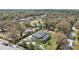 Aerial view of a single-Gathering home with a screened-in pool and well-maintained landscaping surrounded by mature trees at 1810 Markham Woods Rd, Longwood, FL 32779
