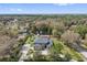 Aerial view of a sprawling home surrounded by lush greenery with a large, screened-in pool at 1810 Markham Woods Rd, Longwood, FL 32779