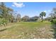 Expansive backyard, screened-in pool, and lush greenery provide a private outdoor oasis at 1810 Markham Woods Rd, Longwood, FL 32779