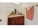 Bathroom vanity with cherry cabinets, granite countertop, and decorative mirror is roomy at 1810 Markham Woods Rd, Longwood, FL 32779