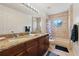 Neutral bathroom with granite countertop, double sinks, and a tub/shower combination at 1810 Markham Woods Rd, Longwood, FL 32779
