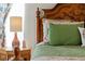 This bedroom showcases the bed's green quilted cushions and floral linens at 1810 Markham Woods Rd, Longwood, FL 32779