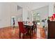 Spacious dining room featuring hardwood floors, modern lighting, and a large window at 1810 Markham Woods Rd, Longwood, FL 32779
