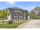 Charming two-story home showcasing a well-maintained lawn and mature trees at 1810 Markham Woods Rd, Longwood, FL 32779