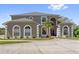 Beautiful two-story home with an inviting entrance and circular driveway at 1810 Markham Woods Rd, Longwood, FL 32779