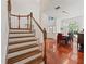 Grand foyer with hardwood staircase, dining area, chandelier, and bright natural light at 1810 Markham Woods Rd, Longwood, FL 32779