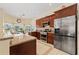 Spacious kitchen with stainless steel appliances, granite counters, and cherry wood cabinets at 1810 Markham Woods Rd, Longwood, FL 32779