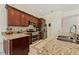 Kitchen with stainless steel appliances, granite counters, and cherry wood cabinets at 1810 Markham Woods Rd, Longwood, FL 32779