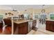 Kitchen with stainless appliances, granite counters, cherry cabinets, and adjacent breakfast nook at 1810 Markham Woods Rd, Longwood, FL 32779