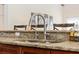 Kitchen island sink with granite countertop and cherry cabinets offers style and functionality at 1810 Markham Woods Rd, Longwood, FL 32779