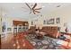 Spacious living room and kitchen area with hardwood floors, modern appliances, and bar stool seating at 1810 Markham Woods Rd, Longwood, FL 32779