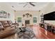 Inviting living room with a fireplace, hardwood floors, leather sofas, and large windows at 1810 Markham Woods Rd, Longwood, FL 32779