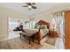 A grand main bedroom features a carved wooden bed frame and bright, natural lighting at 1810 Markham Woods Rd, Longwood, FL 32779