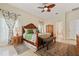 This main bedroom showcases a grand wooden bed frame and elegant floral curtains at 1810 Markham Woods Rd, Longwood, FL 32779