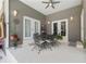 A covered patio features neutral paint, ceiling fan, decorative sconces, and outdoor dining set at 1810 Markham Woods Rd, Longwood, FL 32779