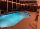 Inviting pool with screened enclosure, landscape features, and surrounding patio create a private outdoor oasis at 1810 Markham Woods Rd, Longwood, FL 32779