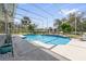 Sparkling screened-in pool with deck, landscaping, and views of the backyard at 1810 Markham Woods Rd, Longwood, FL 32779