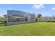 A well manicured lawn leads to an extended screened-in patio and outdoor seating space at 1810 Markham Woods Rd, Longwood, FL 32779