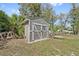 A wooden storage shed with a double door and an architectural design adds to the yard at 1810 Markham Woods Rd, Longwood, FL 32779