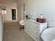 Upstairs hallway with white dresser, two white chairs, and carpeting at 3850 Oakville Ave, Kissimmee, FL 34741