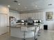Kitchen with large island, white cabinets, granite countertops and breakfast bar at 3850 Oakville Ave, Kissimmee, FL 34741