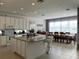 Large kitchen with island, white cabinets, granite counters, and breakfast nook at 3850 Oakville Ave, Kissimmee, FL 34741