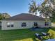 Backyard with patio, lawn, and lounge chairs at 545 Pintail Cir, Auburndale, FL 33823