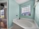 Relaxing bathroom with soaking tub, tile shower, and updated vanity at 545 Pintail Cir, Auburndale, FL 33823