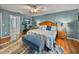 Spacious Primary bedroom featuring wood floors, ceiling fan and ensuite bath at 545 Pintail Cir, Auburndale, FL 33823