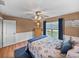 Bright bedroom with wood floors and ceiling fan at 545 Pintail Cir, Auburndale, FL 33823