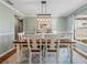 Farmhouse style dining room with rustic wooden table and chandelier at 545 Pintail Cir, Auburndale, FL 33823