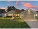 House exterior at dusk showcasing landscaping and driveway at 545 Pintail Cir, Auburndale, FL 33823