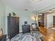 Office corner with dark wood cabinet, comfortable chair and natural light at 545 Pintail Cir, Auburndale, FL 33823